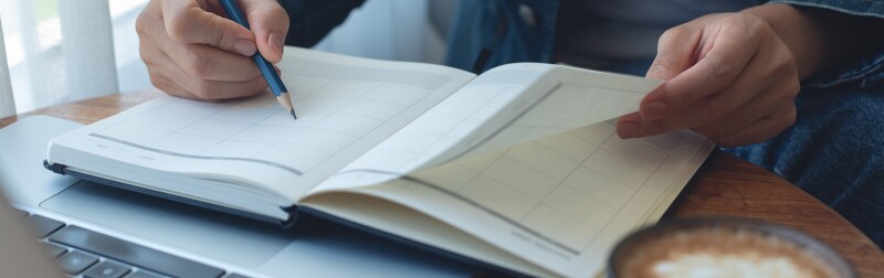 Person in a cafe reviewing a calendar