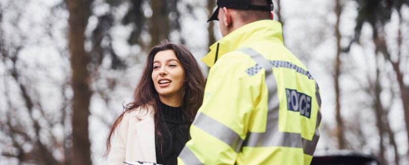 Police officer interviewing young woman