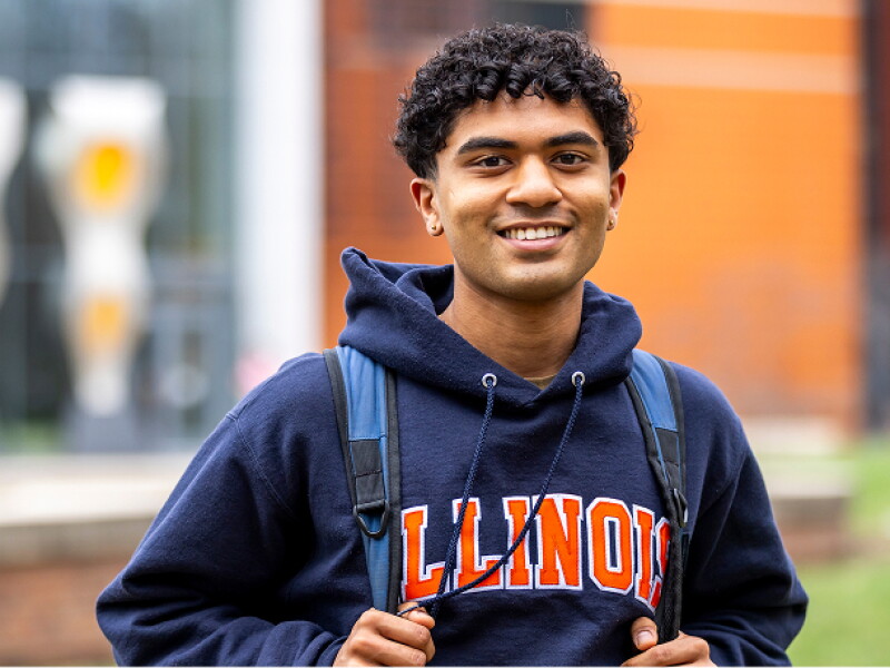 Smiling student wearing a University of Illinois sweatshirt