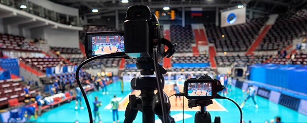 Digital camera filming sporting event as part of a sports media job