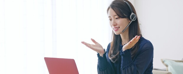 woman wearing headset talking in online meeting