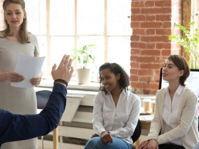 Team leader addressing a coworkers question during an office meeting.
