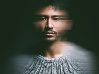 Portrait of young man with blurry face experiencing PTSD