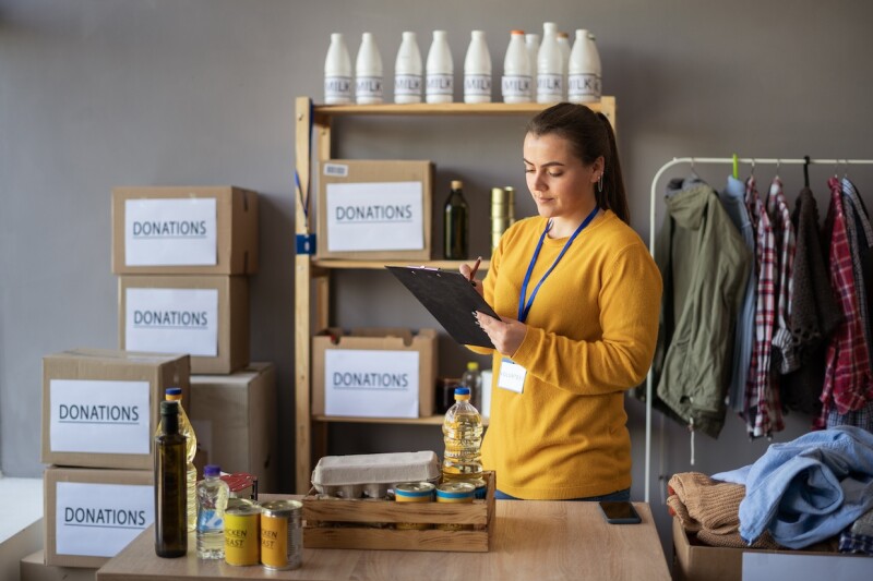 Female volunteer takes account of items for a nonprofit organization.