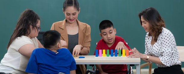 Special education teachers working with a group of students.