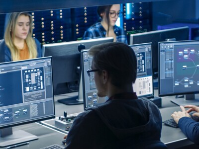 Team of IT Programers Working on Desktop Computers in Data Center System Control Room.