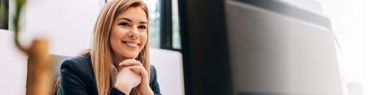 Happy woman sitting at her work desk