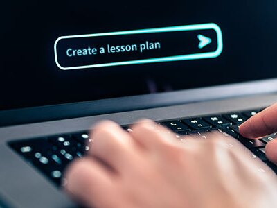 Teacher using AI on laptop to create a lesson plan
