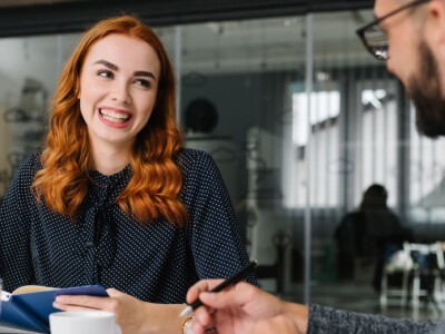 Male and female coworkers brainstorming ideas in conference room