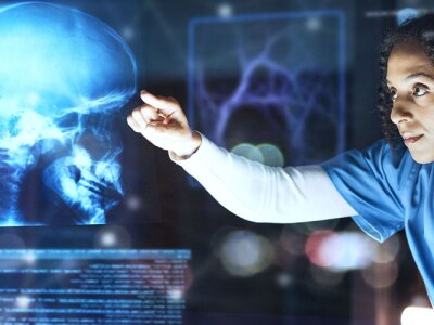 Female nurse using AI to view futuristic skull scan in brain cancer, injury or fracture analytics in night hospital planning.
