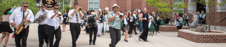 New Orleans band playing brass instruments and drums for audience on Tulane campus
