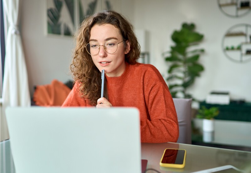 Woman thinking at her laptop