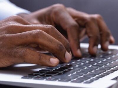 hands typing on a keyboard