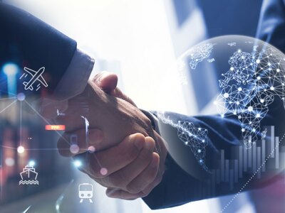 Two people shake hands behind a graphic suggesting international travel