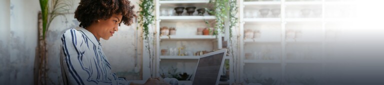 woman in striped blouse using a laptop