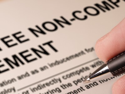 Man signing an employee Non-compete agreement