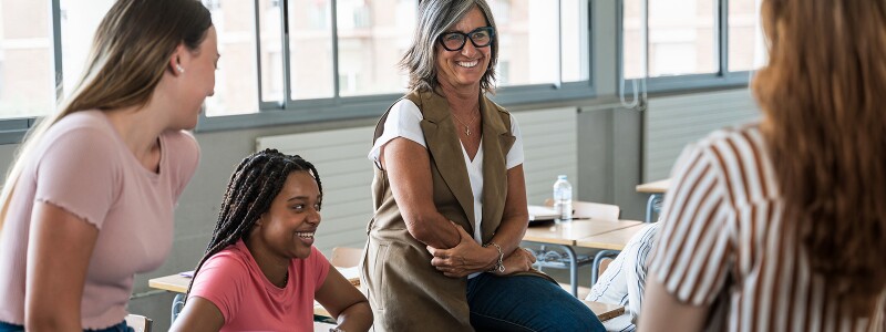 School counselor guiding female high school students during a group session