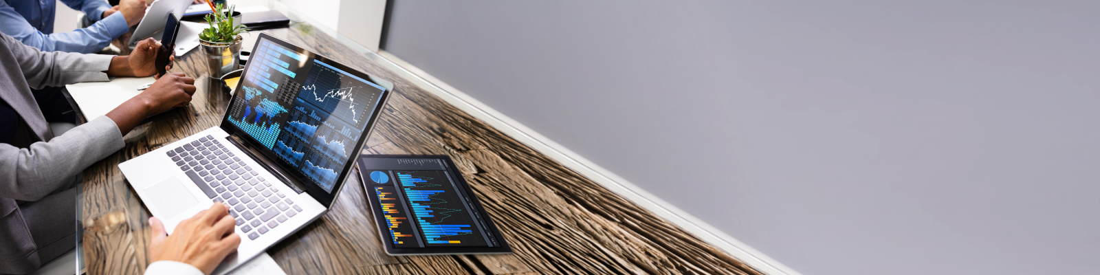 employees working with data on laptop and tablet