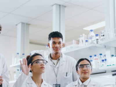 A diverse group of clinical researchers in lab listening during a discussion