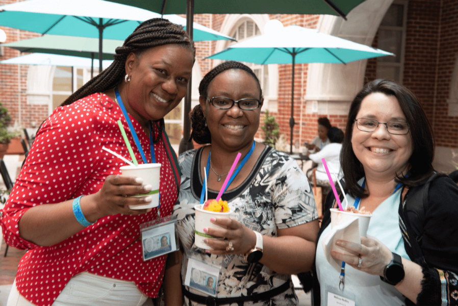 Three Tulane students holding frozen desserts and smiling
