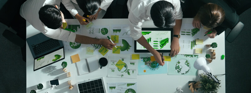 room of engineers planning with tablets and charts