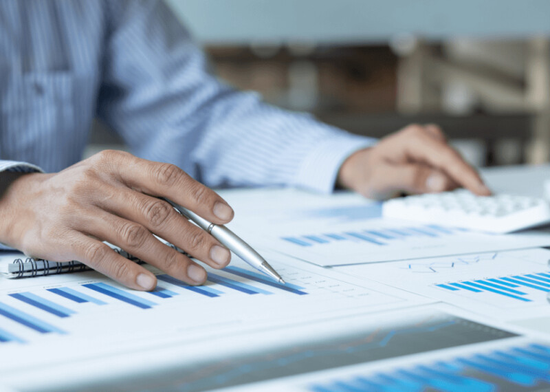 A financial manager looking a printed graphs