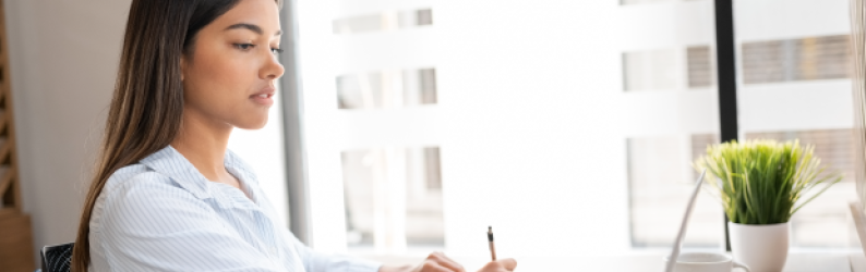 Professional woman working on laptop at her desk