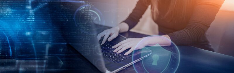 Person typing on laptop displaying cybersecurity icons
