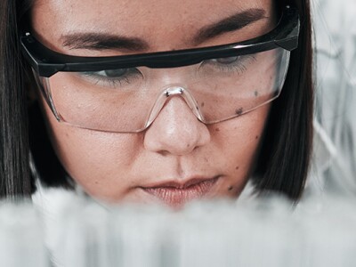 Biomedical engineer looking thoughtfully at her work