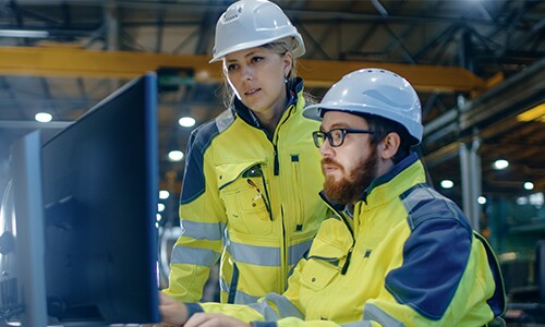 two engineers looking at computer
