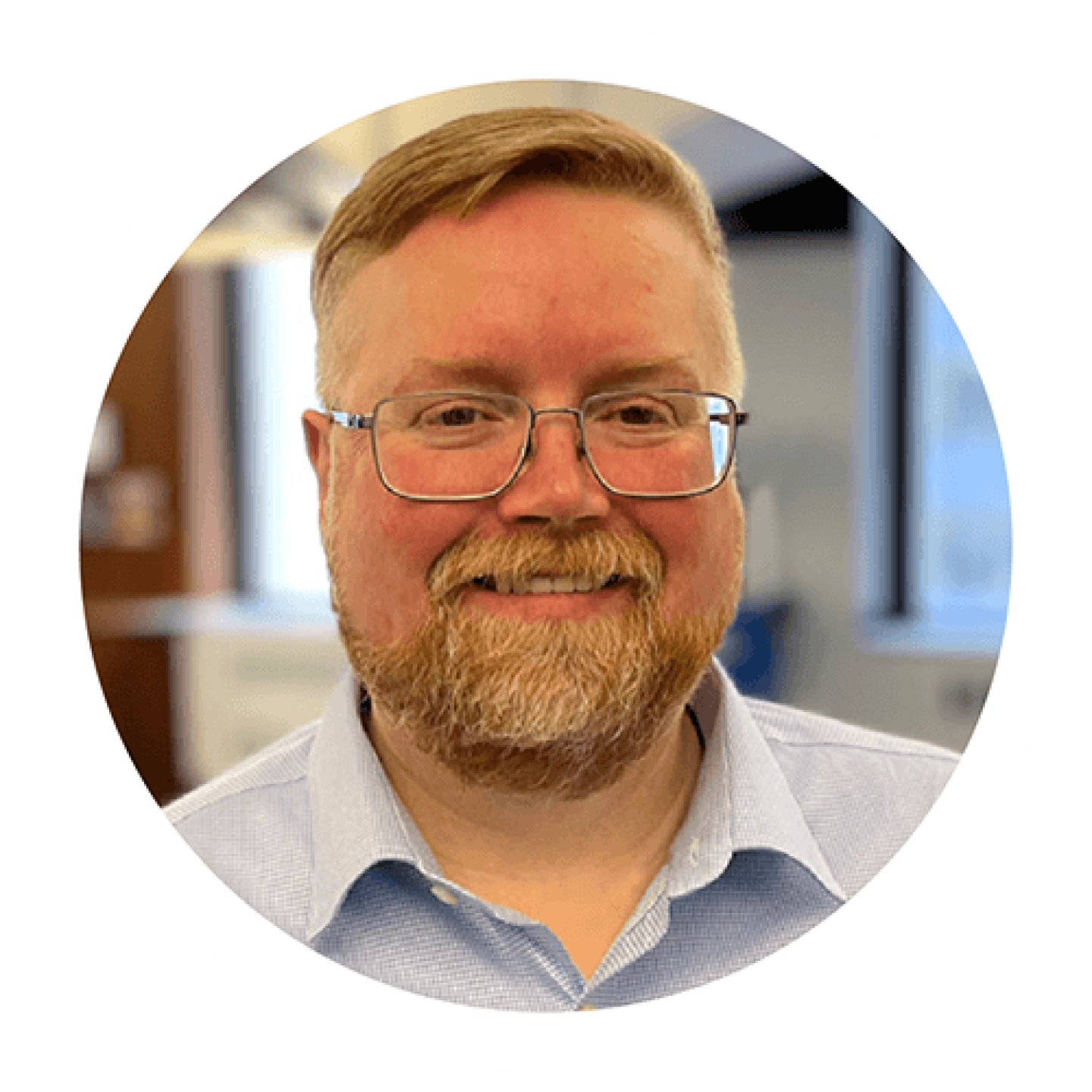 Headshot of Neil Marchant, CFO at Everspring, smiling and wearing glasses and a light blue collared shirt.