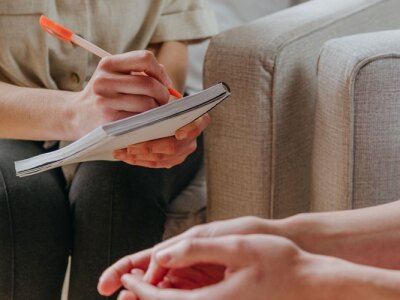 Young woman talking about her problems and issues with a counselor.