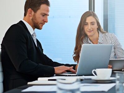 a diverse group of modern professionals discussing legal and technology issues in an office