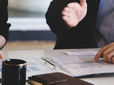 Corporate managers are reviewing documents to restructure the company.