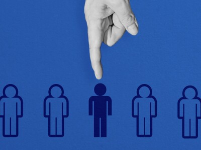 A hand selecting a figure from a lineup of people icons