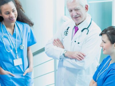 Healthcare professionals meeting in a hospital stairwell.