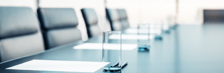 Empty boardroom with empty glasses of water on the table