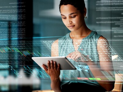 Business woman with tablet, overlay of charts