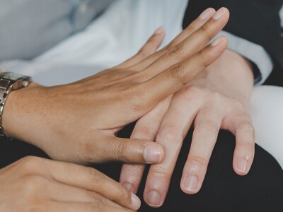 Employee woman defending at hand of colleague touching her knee