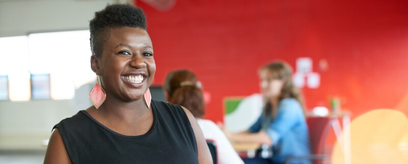 Confident woman working in red creative office space