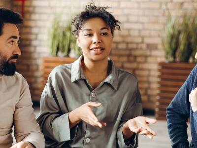 Clients listen to a social worker during a group session