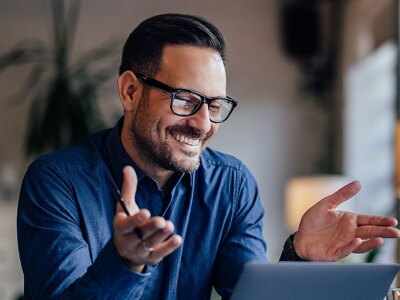 Smiling sports agent, talking to his clients, having an online meeting.