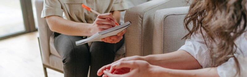 Young woman talking about her problems and issues with a counselor.