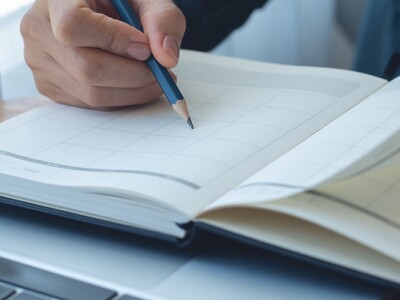 Person in a cafe reviewing a calendar