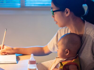 Asian mother and child Sitting and working at home at night.