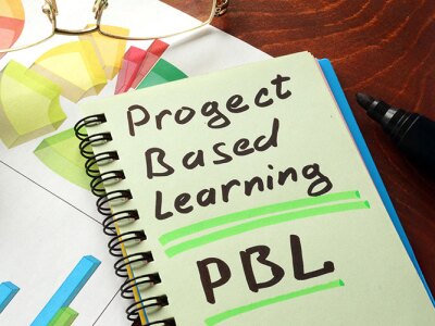 A spiral notebook with the words Project Based Learning written on it.
