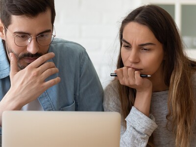 Couple at laptop thinking about their finances