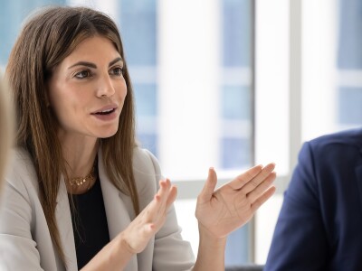 Female business executive leading a meeting of diverse colleagues