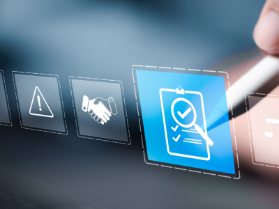 Hand holding stylus selects an icon on a digital screen.