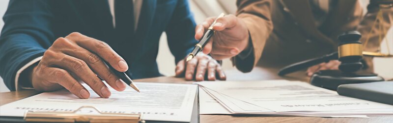 Judge gavel with health law lawyers having team meeting at law firm background.